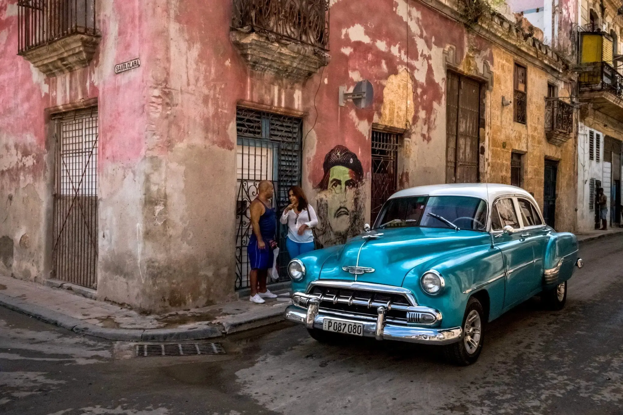 blue classic car parked on the street in Havana