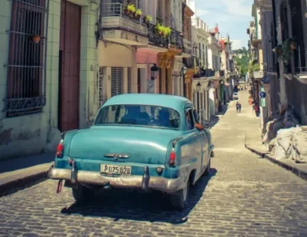 blue classic car in streets of havana